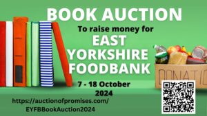 A shelf with books on the left and a box of food donations on the right. 