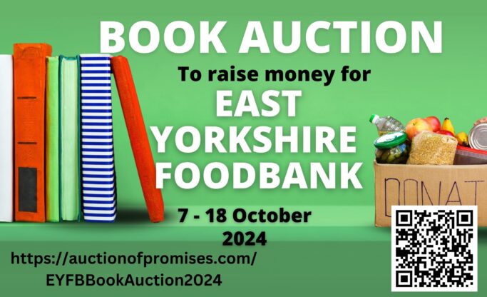 A shelf with books on the left and a box of food donations on the right.